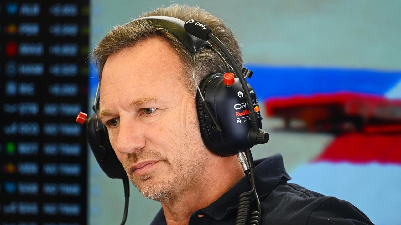 Christian Horner (centre) with team adviser Helmut Marko (left) during the third day of Formula One pre-season in Bahrain. (Photo by Andrej ISAKOVIC / AFP)